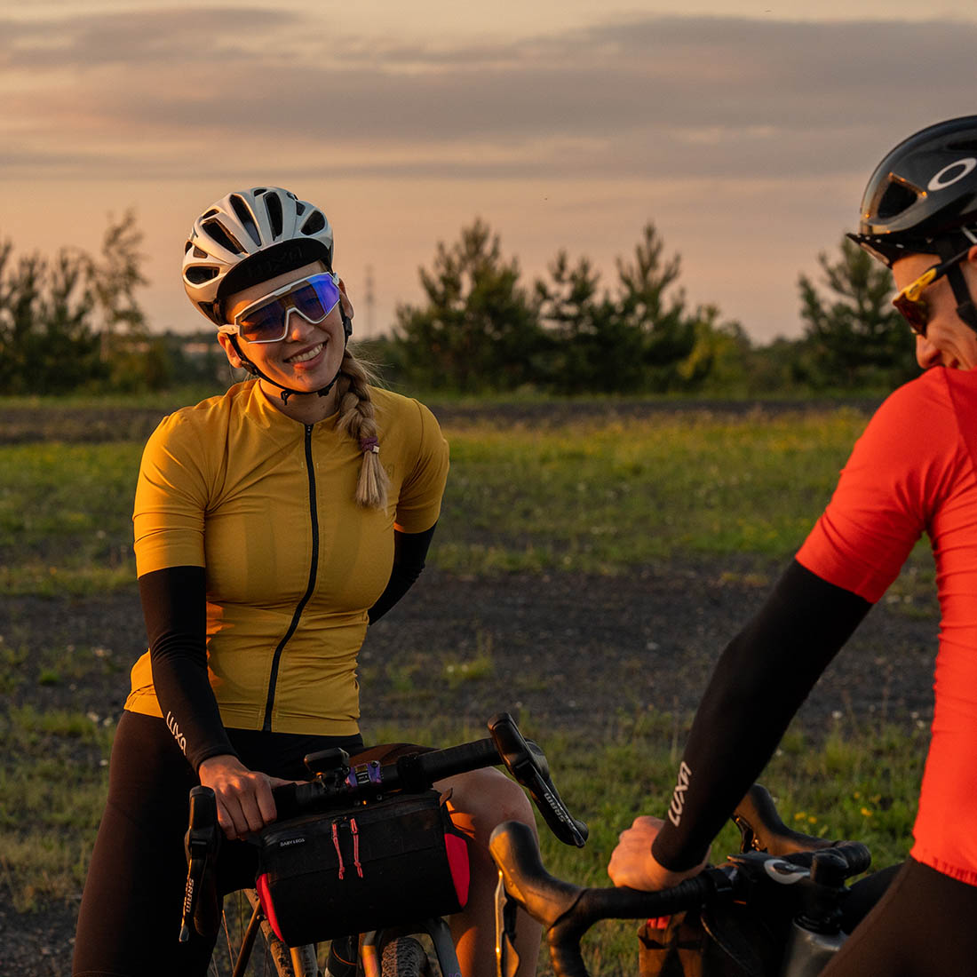 cycling couple wearing arm warmers during sunset ride